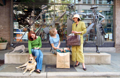 Three women in front of the Shopping Daze sculpture. (Source: Explore Asheville )