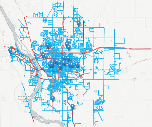 Schools in Bismarck., N.D., and their connections to the city's biking network. The highest-stress streets are in red.