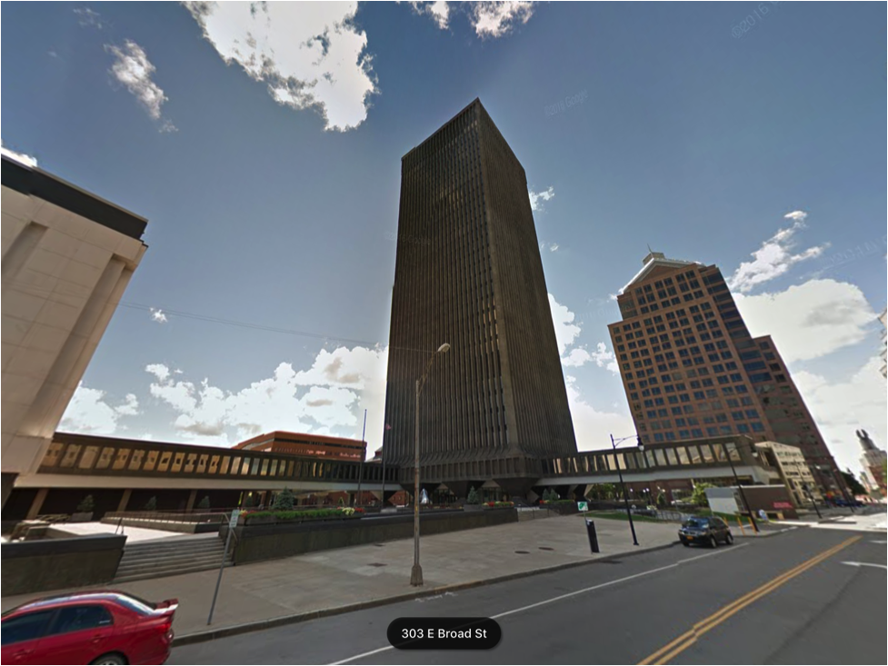 Xerox Square offers nothing to the vitality of Rochester’s streetlife and as a result, not a soul is to be found in this late-afternoon picture. Notice the deliberate effort on so many levels to kill street life. The second story skyway was designed to keep people off of the streets and in the various office buildings of downtown. Ramps to the underground parking garage break through sidewalks on all four sides of the development, destroying any hope for continuous street level activation. Even the street level entrance to the tower is tucked away behind massive pillars at the base and limited to a small vestibule surrounding the elevator core. There are no shops, no restaurants, no apartments, and therefore, no reason to be here. (Image from Google Earth)