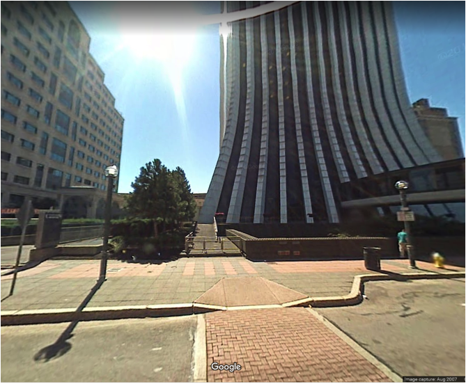 Any street level amenities in this block of renewal? Not for 40 years. In this photo from 2007, you will see just a ramp to a parking garage, metal gate, and three-foot tall wall topped with spikes. And yes, that tube over the street was a main entrance to Rochester’s third tallest tower. Fortunately, the redevelopment of the tower has since removed the skyway, constructed a proper entrance at street level, and added housing. (Image from Google Earth)