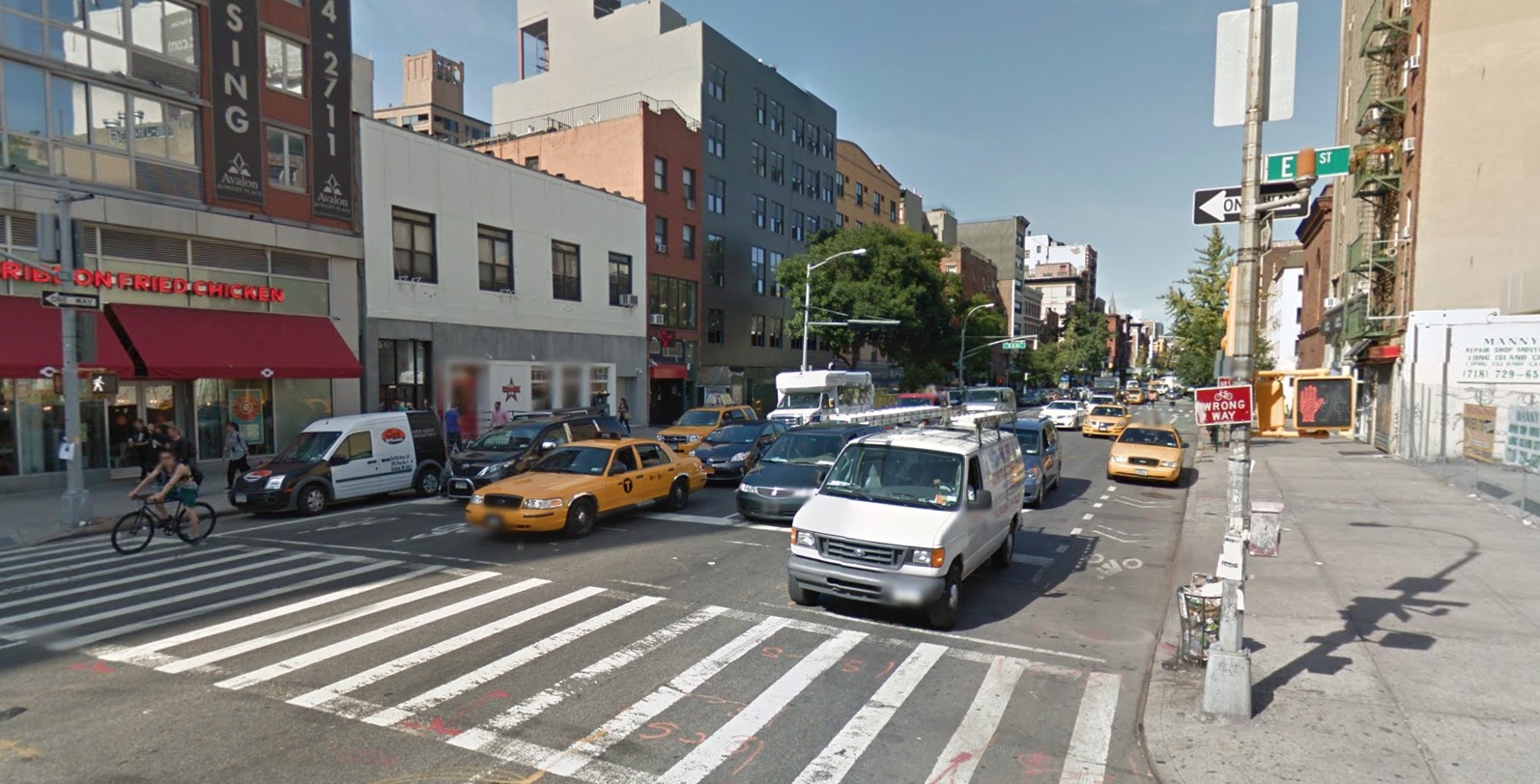 The street where Sam was struck. Note that the bike lane (currently occupied by a taxi) is merely striped here, not protected. (Image from Google Maps)