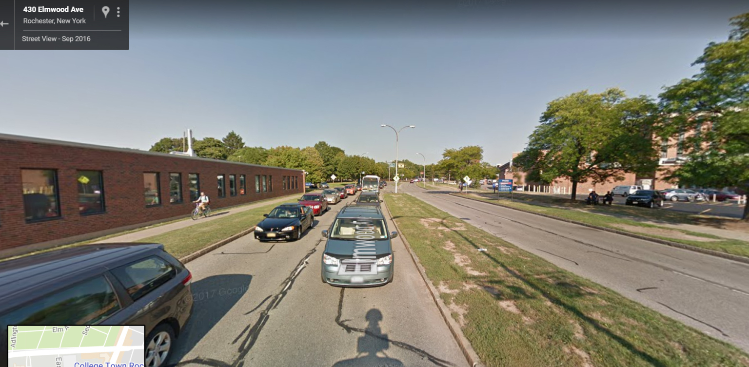Google Street View of Elmwood between the University of Rochester campus and College Town. Traffic congestion, higher speeds, no shoulders or bike lanes and the bare minimum pedestrian infrastructure make this a less-than-inviting on-foot experience for students.