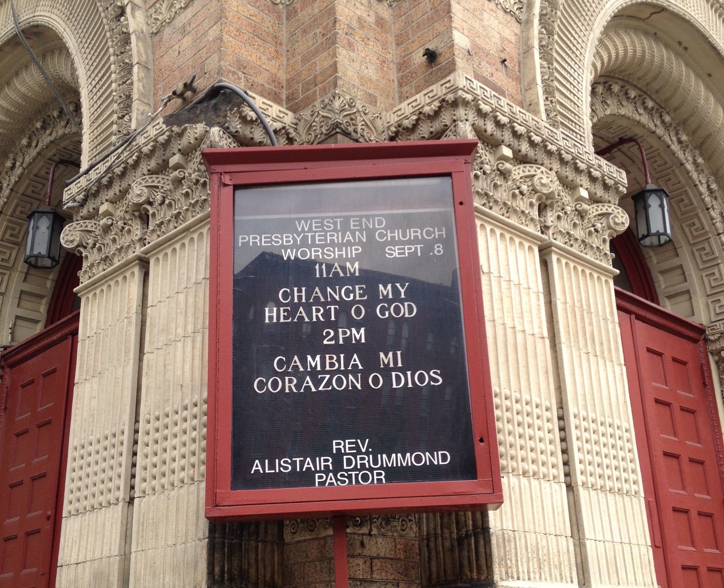 One side of this New York City building advertises church services.