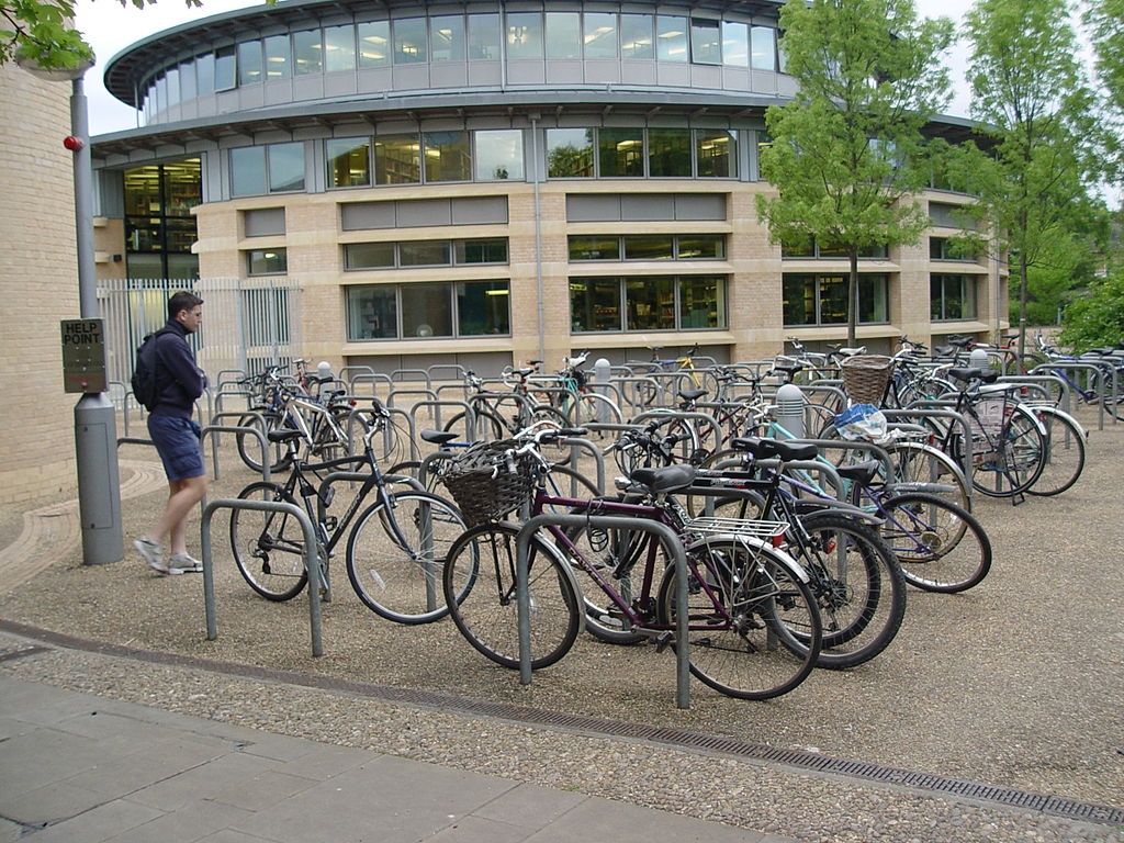 Bike parking near the entrance of a university building makes door to door transportation easy and keeps bikes safe under the watchful eye of passersby. (Source: Christian Mercat)