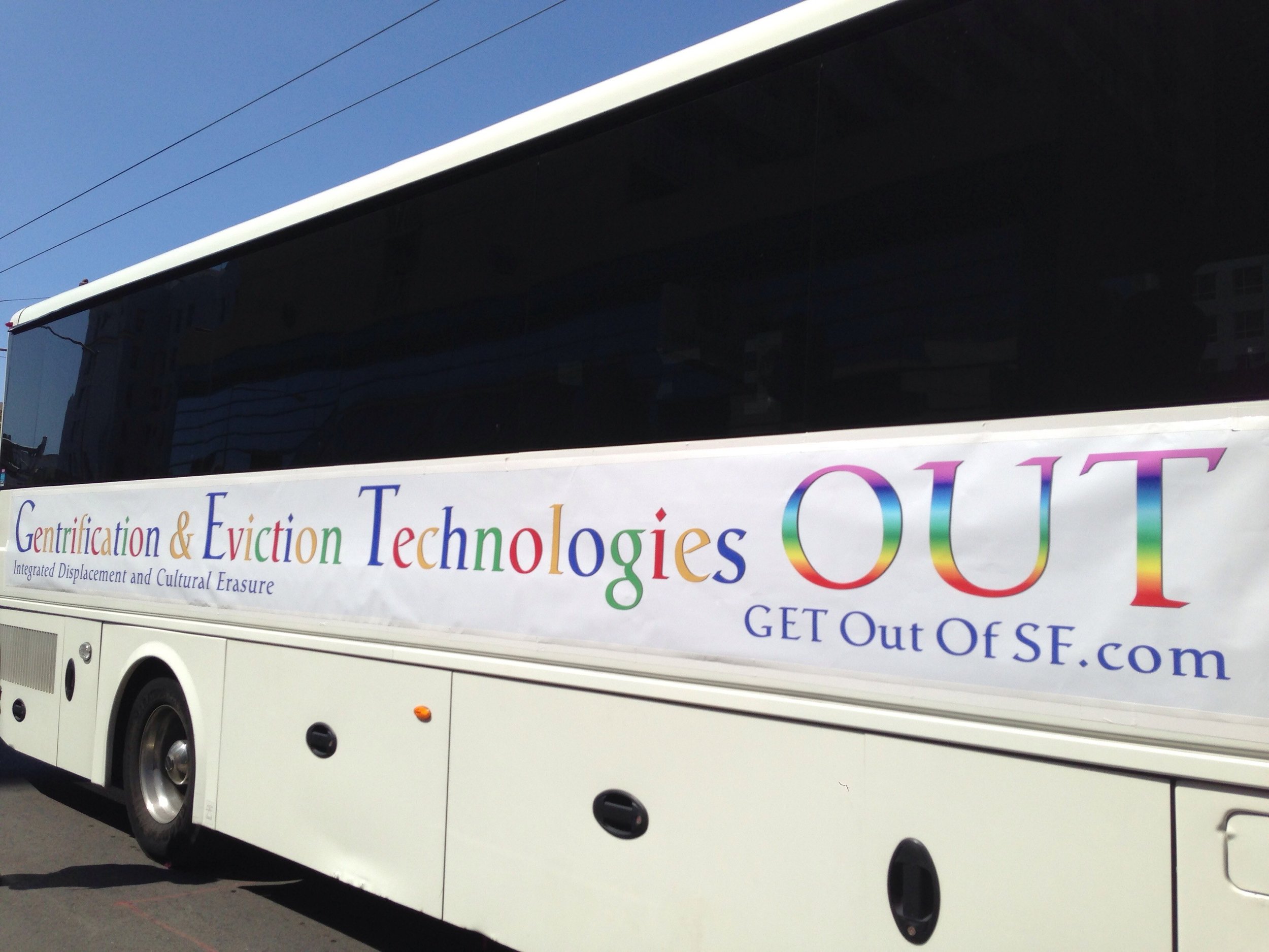Protest banner attached by activists to a Google employee shuttle in San Francisco. (Source: Steve Rhodes via Flickr )