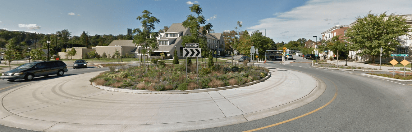 The same intersection, after the roundabout was constructed. The Inn at Swarthmore is on the other side of the roundabout, and the businesses on Chester are across the roundabout. Swarthmore College lies to the left of the roundabout. (Source: Google Maps)