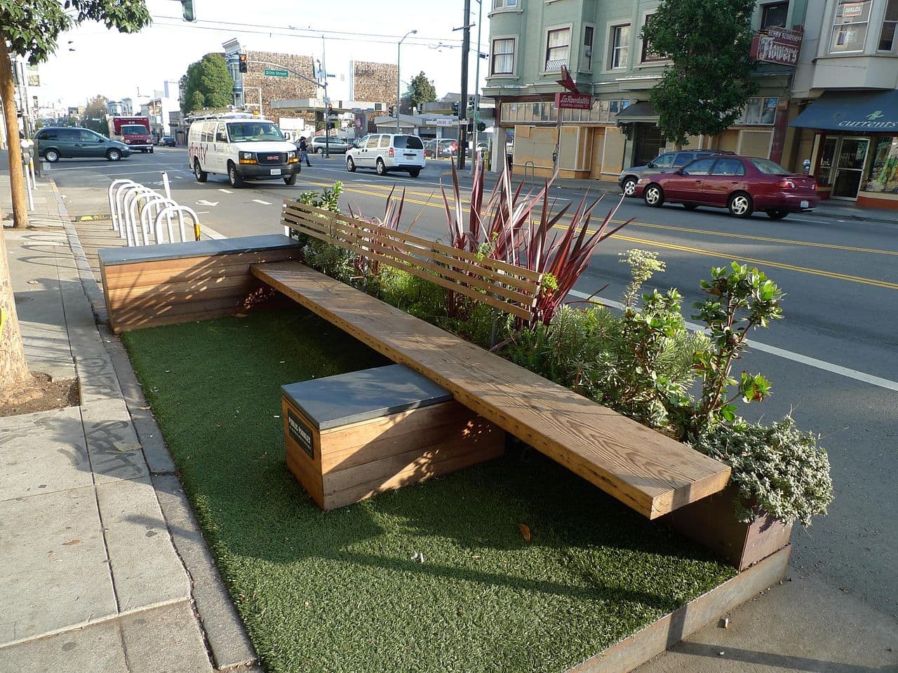A temporary "parklet" in the street helps slow cars and create seating in a quick and easy manner. (Source: Mark Hogan)