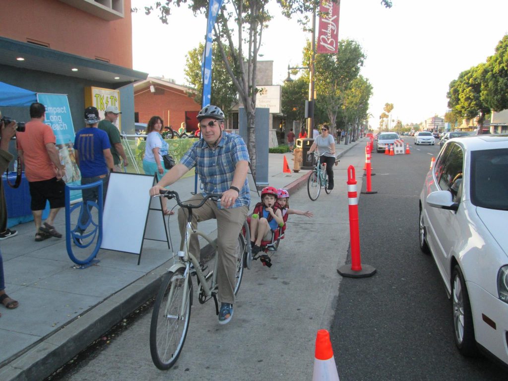 A temporary bike lane helps narrow a street and create safer transportation options (Source: Bike Long Beach )