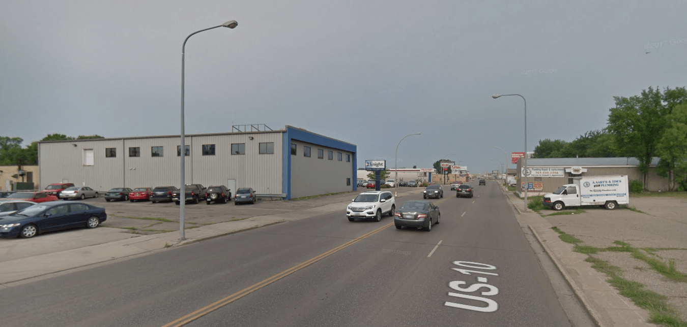 Fast-moving cars and parking lots dominate the auto-oriented Main Avenue. Sidewalks are narrow, neglected and unsafe. (Source: Google Maps)
