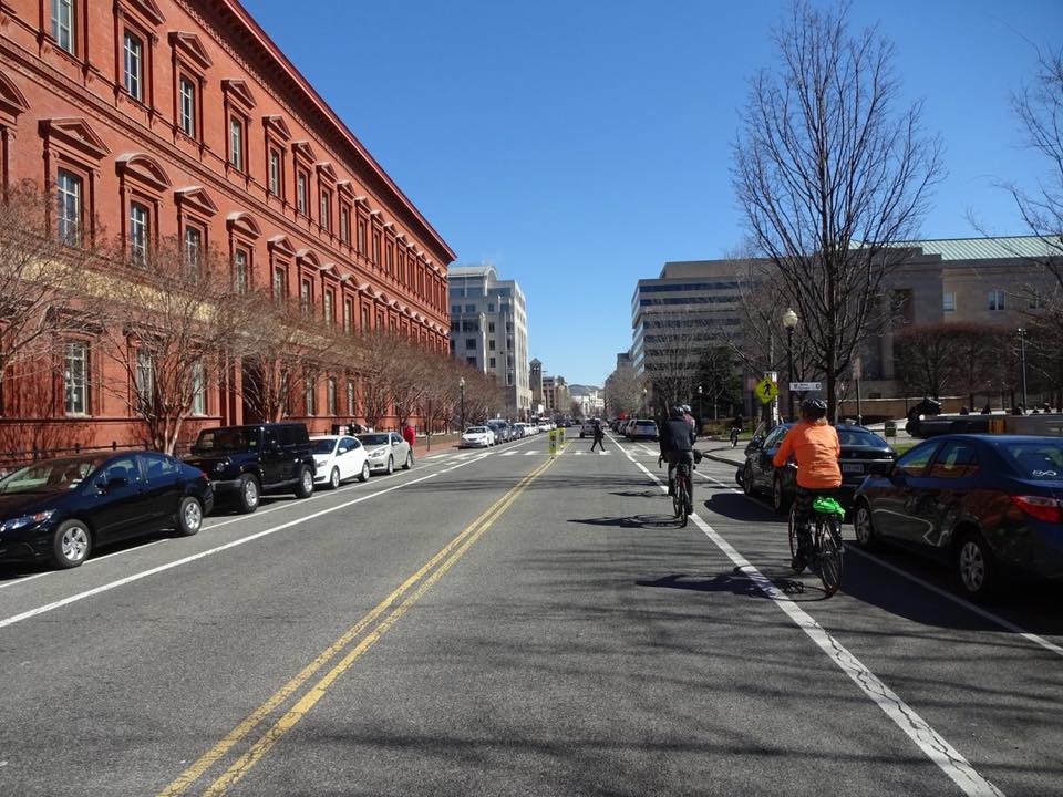 When this photo was posted in the Facebook group, commenters discussed the merits and drawbacks of the bike lane, applauded the mid-block pedestrian crossing, and commented on the surprising lack of traffic for such a wide street.