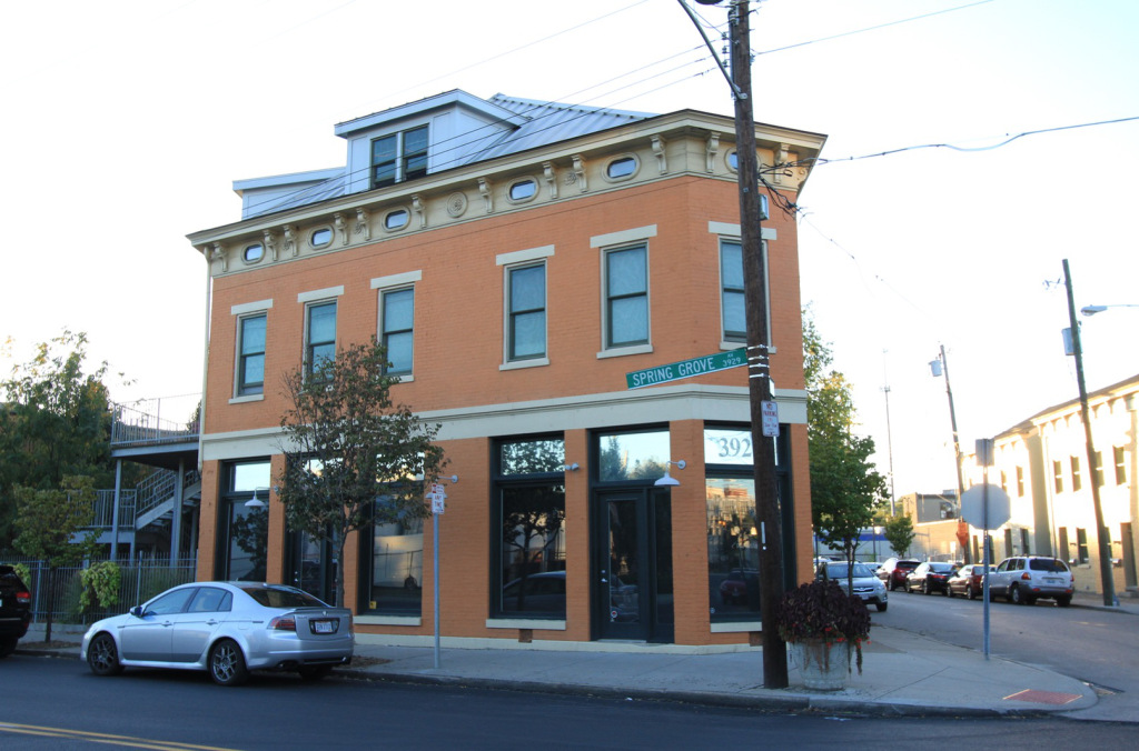 This is a simple mixed-use, multi-family building with a business on the bottom floor and a few housing units on the top floors. (Source: Johnny Sanphillippo)