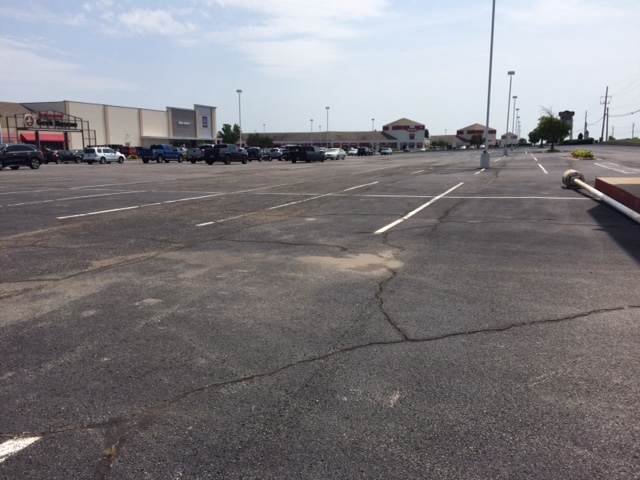 The stores are all open, but where are the cars? Minimum parking requirements waste space in commercial shopping centers. (Photo by Sarah Kobos)