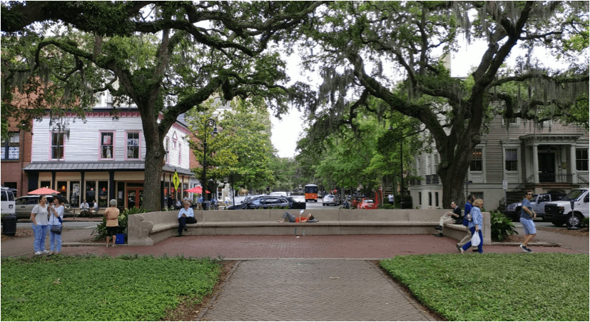On the opposite side of the statue pictured above, where three people are reading in relative solitude on a bench unnoticed.