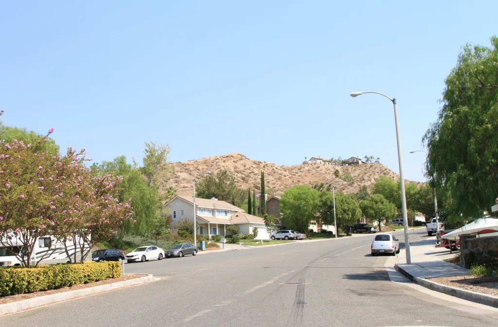 You might wish neighborhood streets like this one weren't so wide and fast-moving, but if the underlying design requirements in your city mandate road width, there's not a lot you can do to make the street safer. Time to change the requirements. (Source: Johnny Sanphillippo)