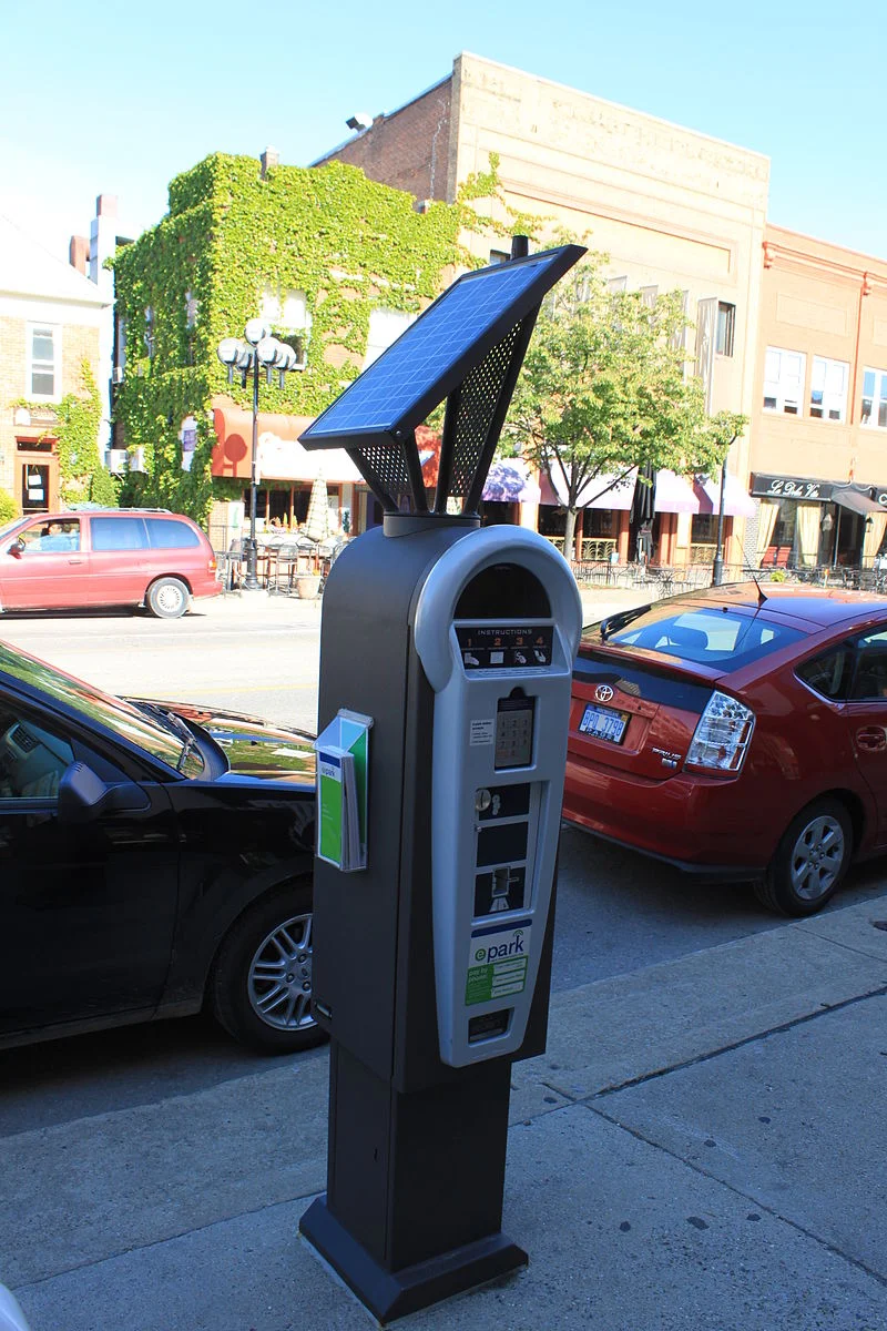 Modern parking pay stations can adjust the price dynamically to be higher at times of high demand, and lower at off hours. The revenue is best devoted to improvements in the neighborhood where meters are installed. (Source: Wikimedia Commons)