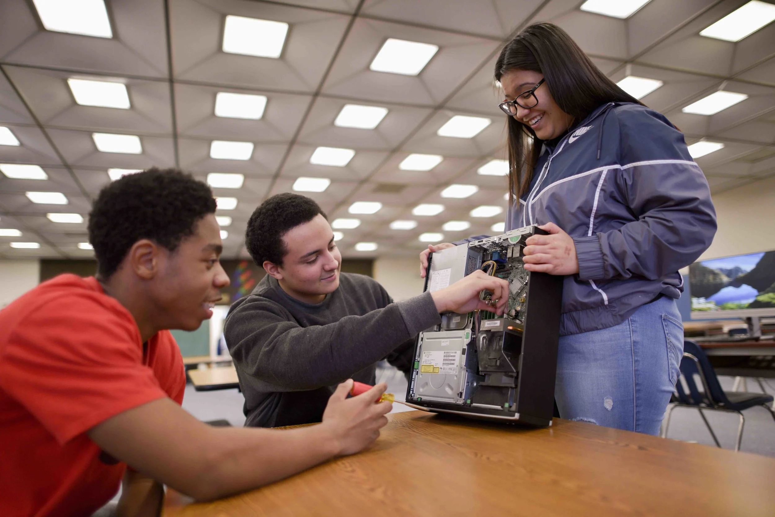 Students at the Academy of Global Technology and Business whose area of interest is IT Support Services examine the inner workings of a computer.