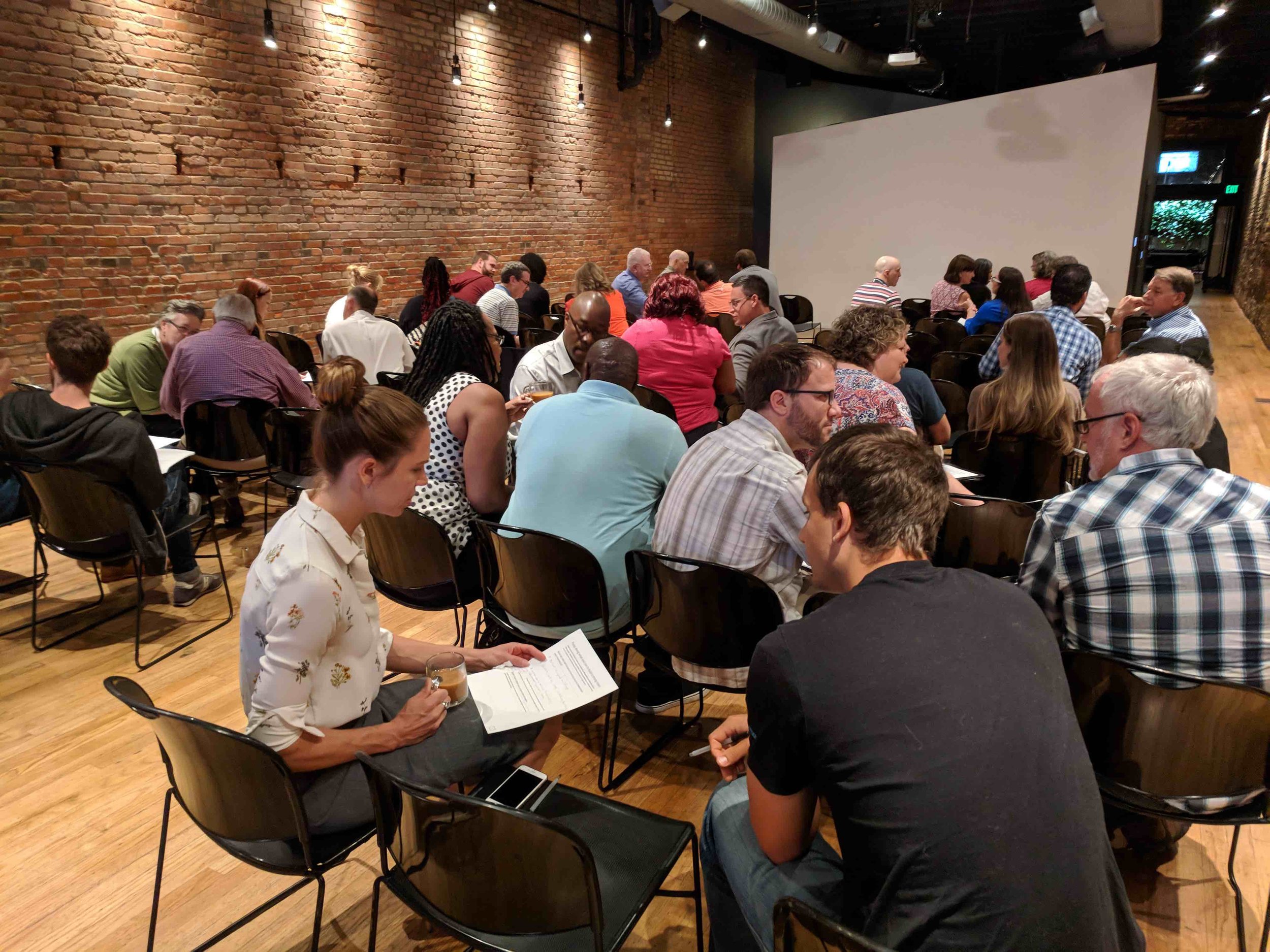 #StrongTownsNTX attendees discuss in small groups their action plans for changing their communities.