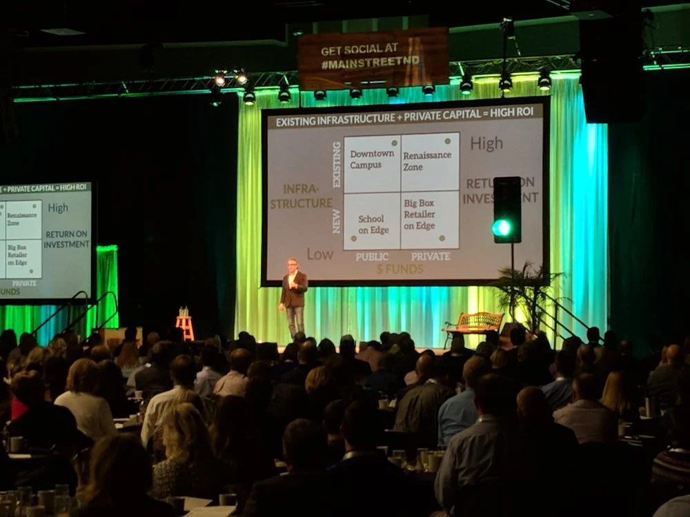North Dakota Governor Doug Burgum presents at the Main Street ND Summit with Chuck Marohn.