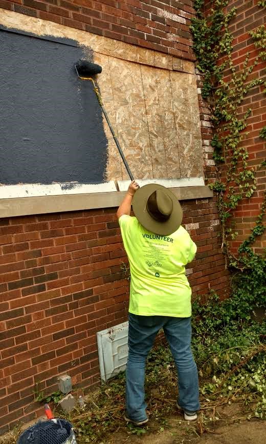 Sue K. painting on a rainy day with few volunteers 8-6-2018.jpg