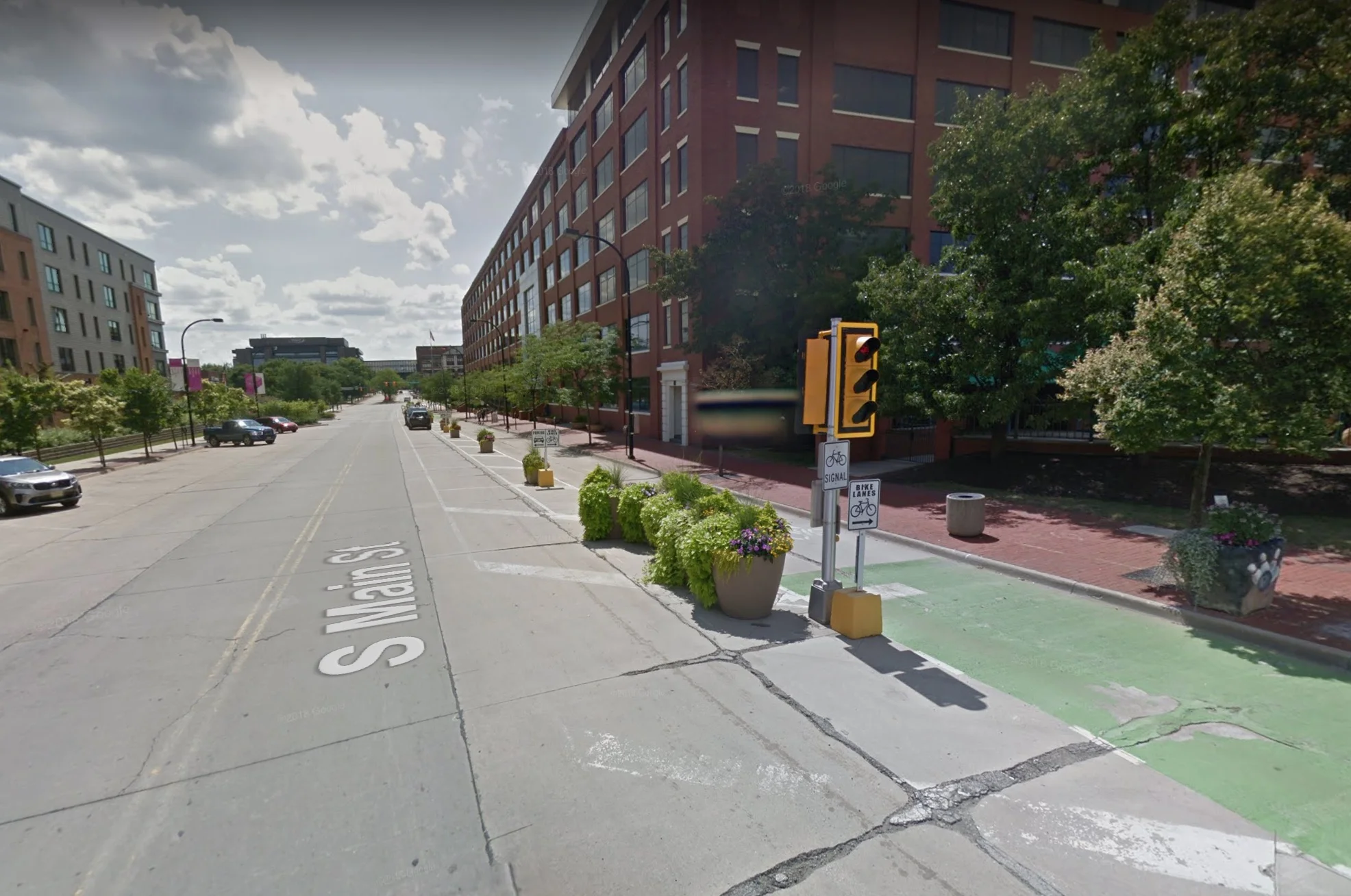 A protected bike lane on South Main Street has become an accepted feature of the streetscape. (Image: Google)