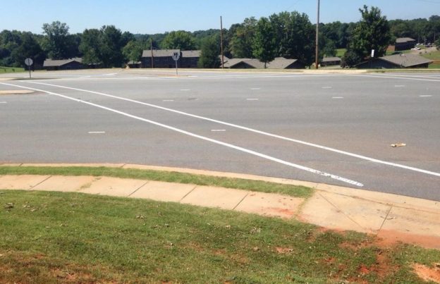 The 160-foot crossing on Oak Street in Forest City, North Carolina. You get nothing but paint, and the least effective crosswalk marking to boot!