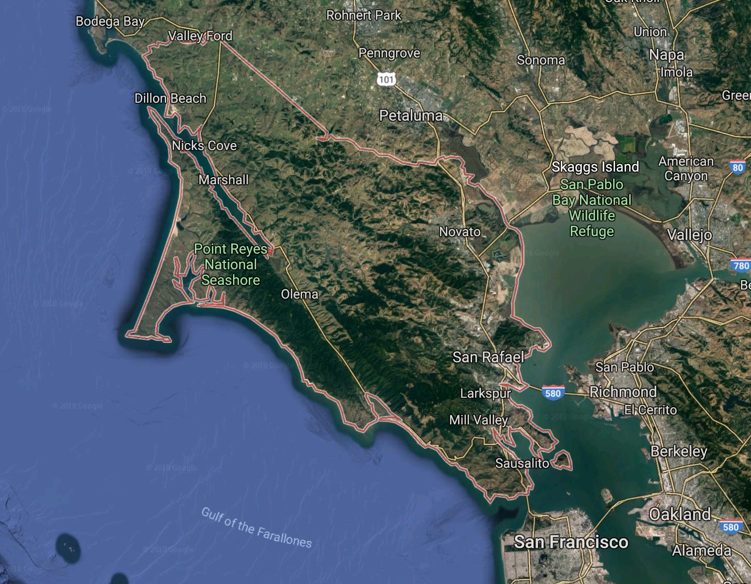 An aerial view of Marin County (outlined in red) shows the concentration of most development in a narrow strip of non-mountainous land along the county’s eastern edge.