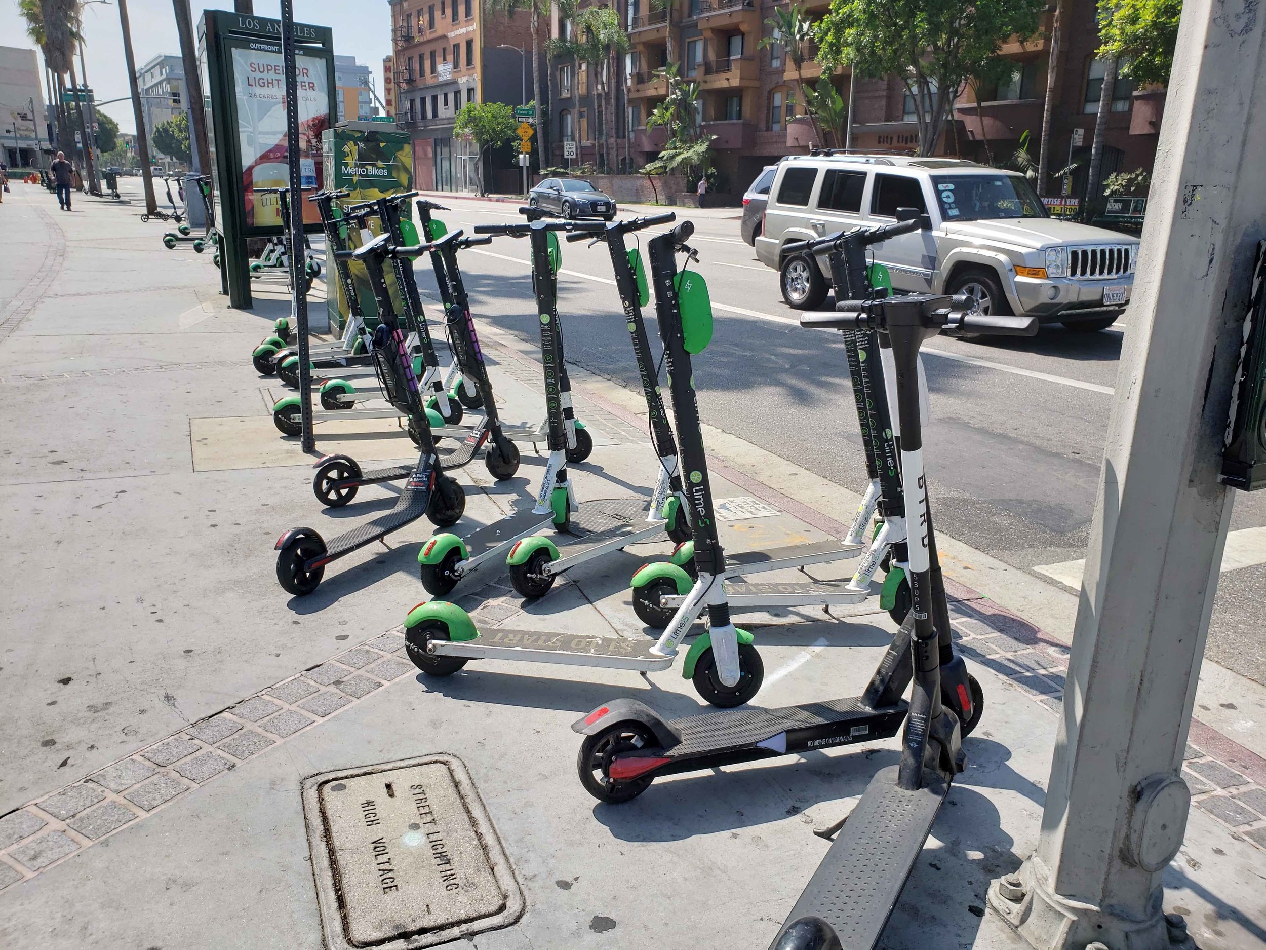 Scooters lined up in downtown Los Angeles—social norms about parking them out of the way of sidewalk users seem to have emerged in the absence of any formal parking arrangements. (Photo by Daniel Herriges)
