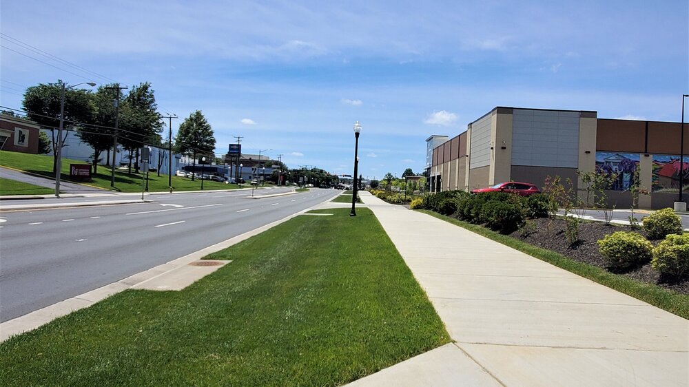 One of two very recent sidewalk segments in front of new developments. It may look similar from the road, but the additional buffer produces a much improved pedestrian experience.
