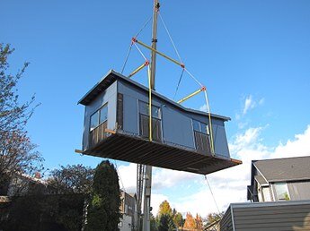 ADU lowered into a backyard.