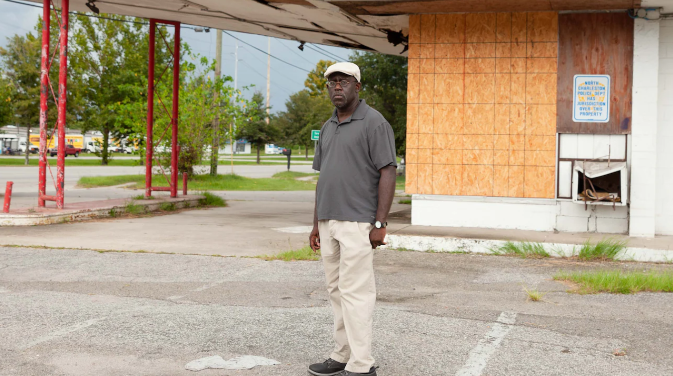 Local historian Damon Fordham standing at the former entrance of the Highland Terrace neighborhood. Image via Washington Post.