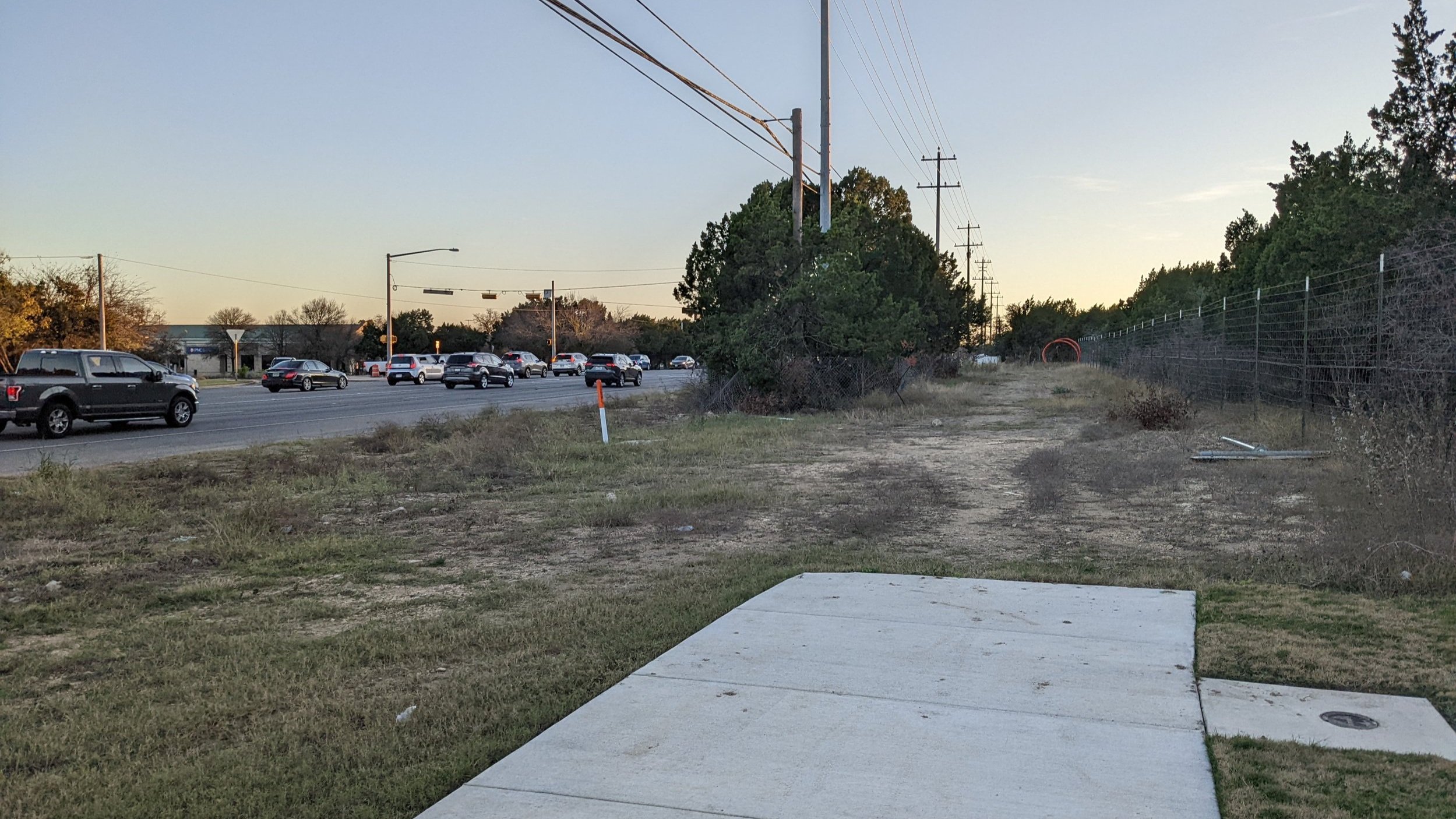  One of the few strips of sidewalk we have  is cut off  before we actually make it to the intersection. There is a beg button, but it’s surrounded by tall, prickly grass. 