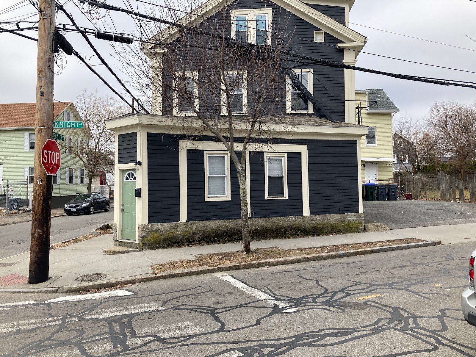  This house had a corner store added on at the first floor, since converted into an apartment. The original storefront windows have been infilled and smaller residential windows were installed. 