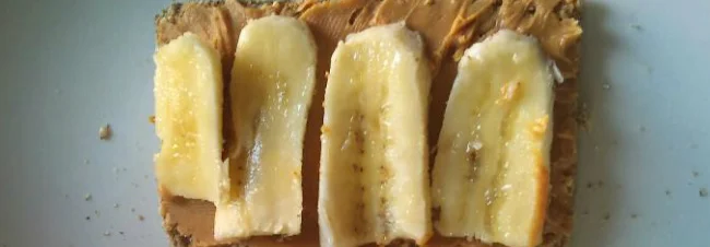 Ryvita with peanut butter and thin slices of banana