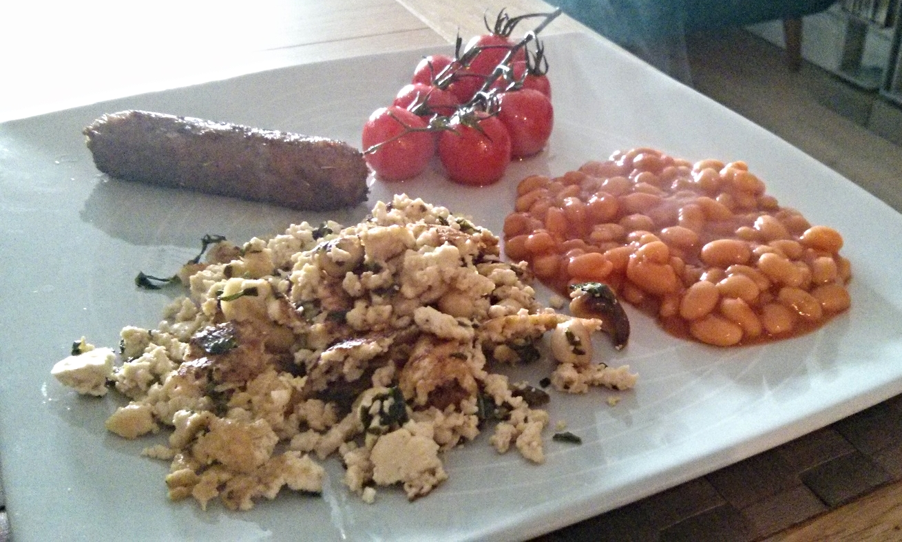 Scrambled tofu with tomatoes, beans and sausages