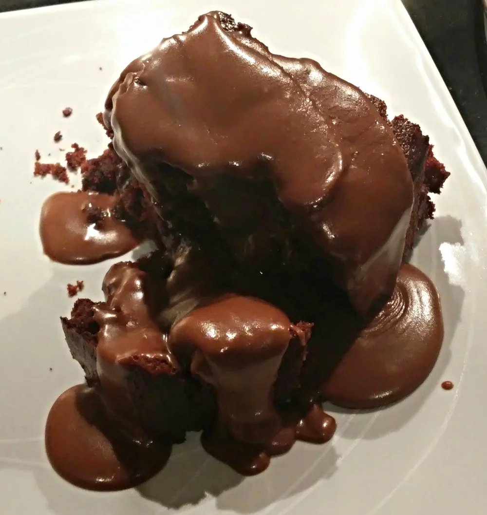 With the icing poured over a slice while the 'sauce' is hot