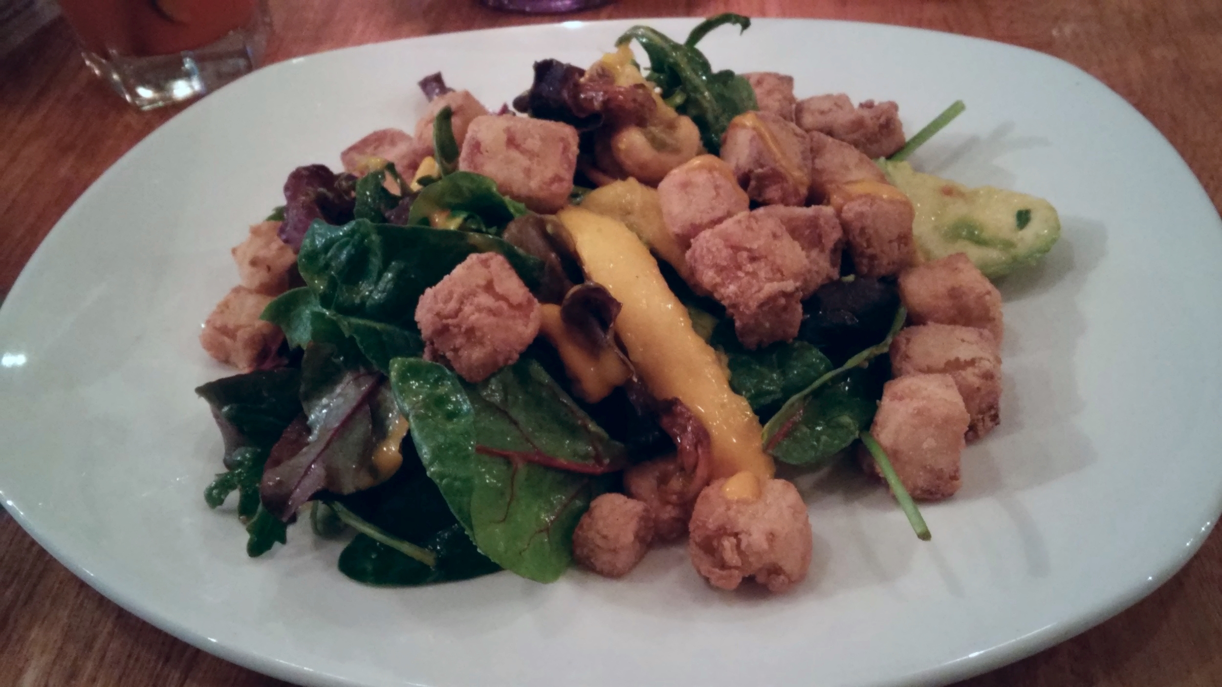 Crispy tofu, avocado and mango salad with baby leaves, wasabi roasted cashews and a mango dressing