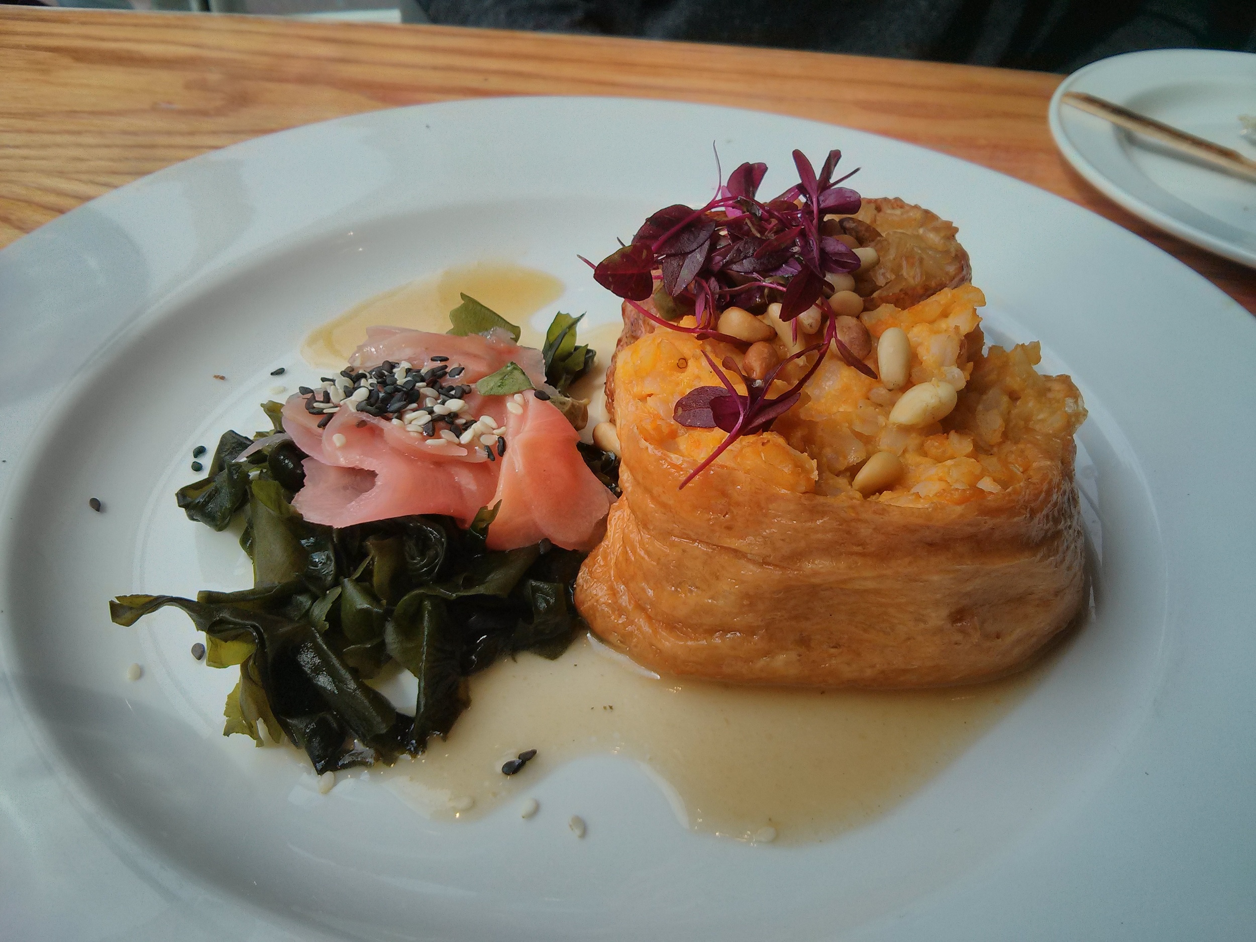 Duo of sweet tofu pockets first stuffed with shiitake rice and pine nuts, second with butternut squash, tofu and miso rice served with pickled   ginger, wakame and a sesame mirin dressing