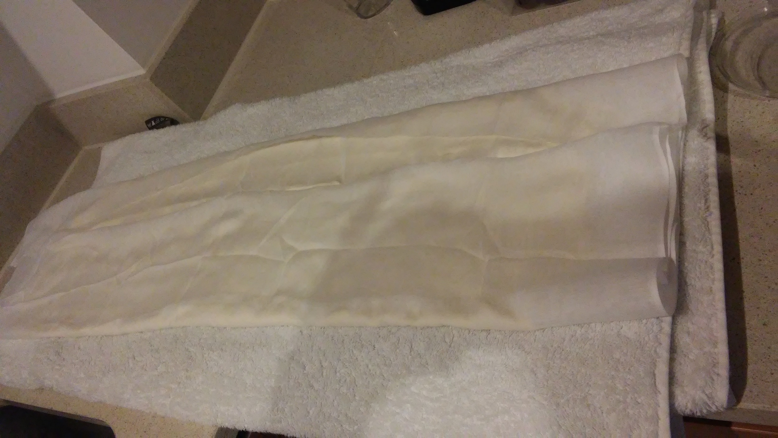 Both sides of the muslin cloth have been folded over to cover the yoghurt