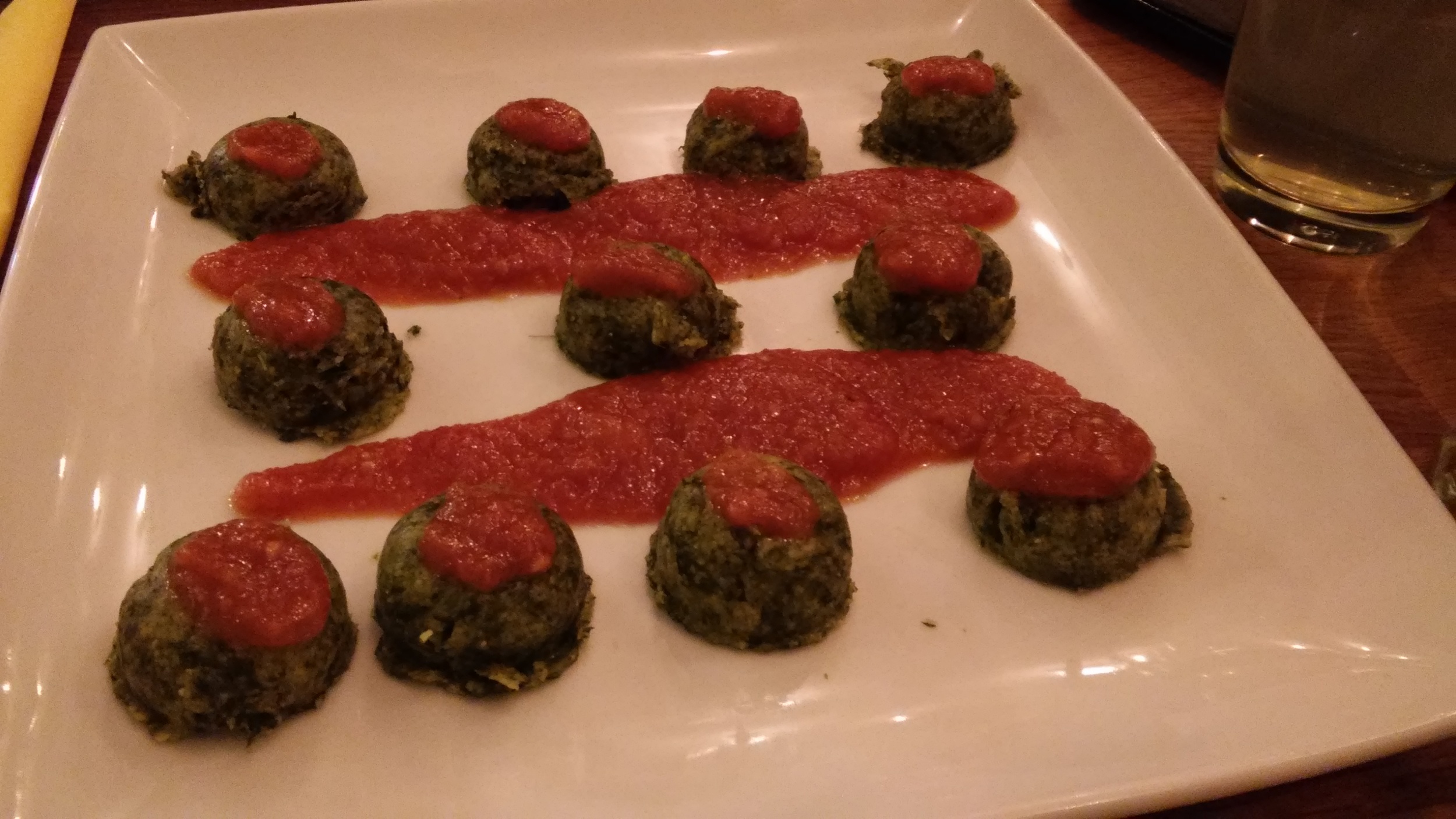 Polenta gnocchi with spinach and tomato sauce