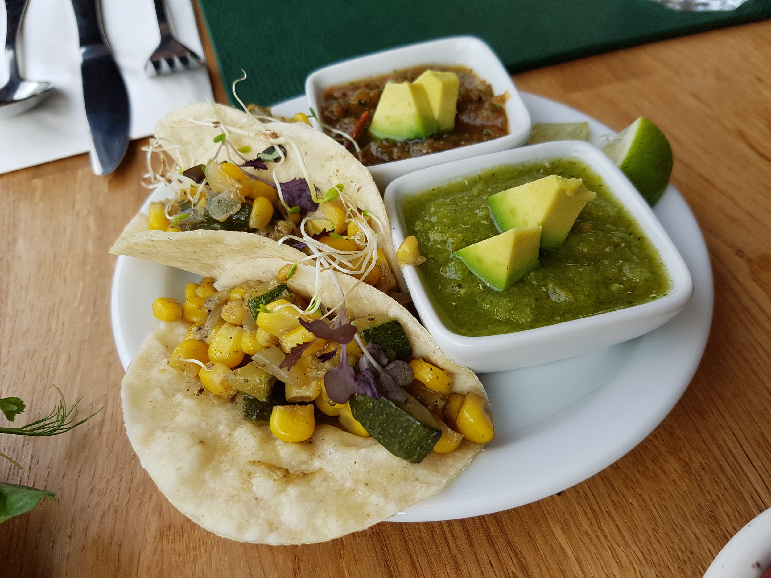 Spring tacos: soft corn tortilla filled with spicy sweetcorn and courgette salsa, served with a pot of guacamole 