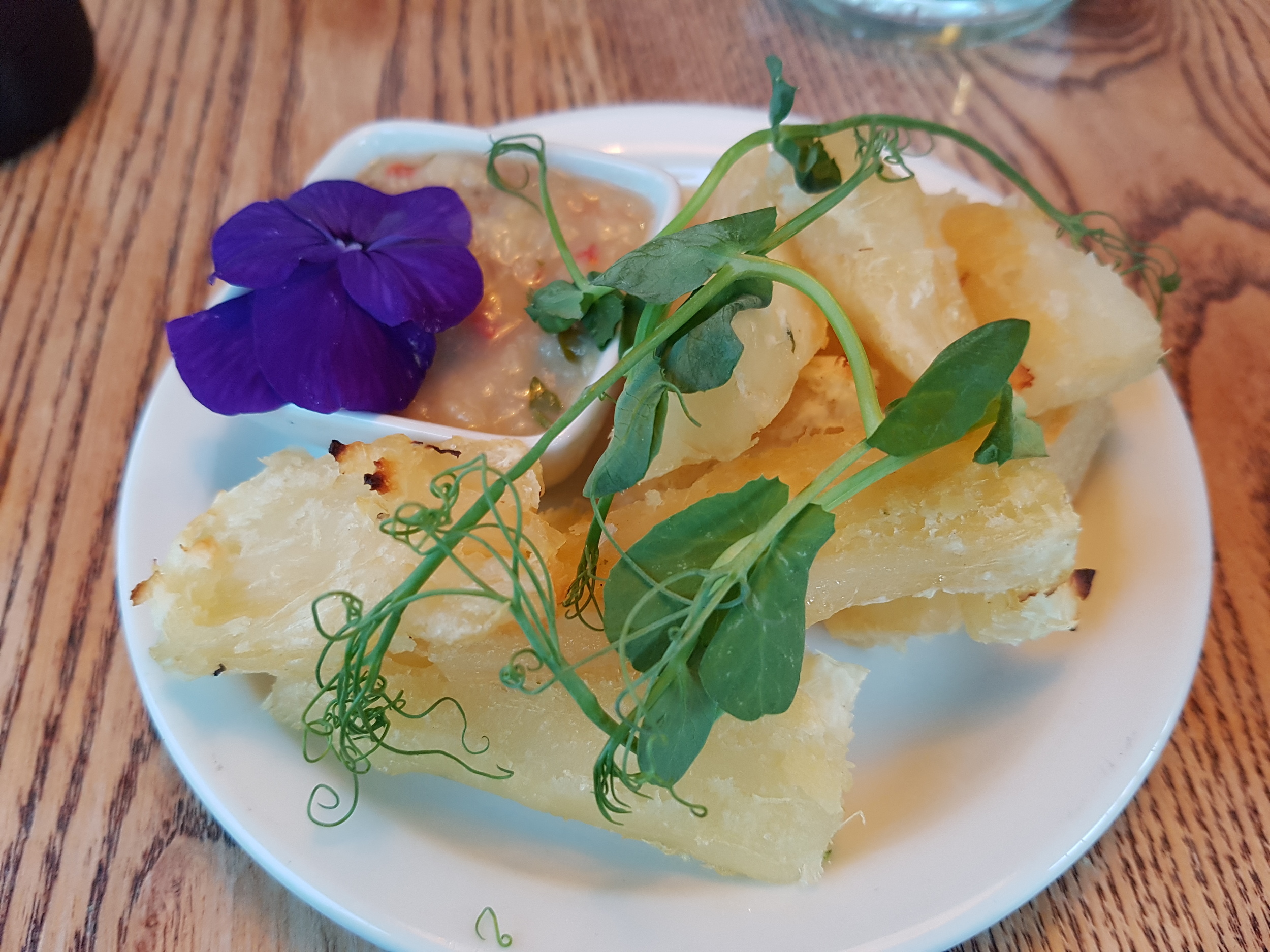 Baked cassava chips poached in veg stock, roasted until crispy, served with banana and green chilli ketchup