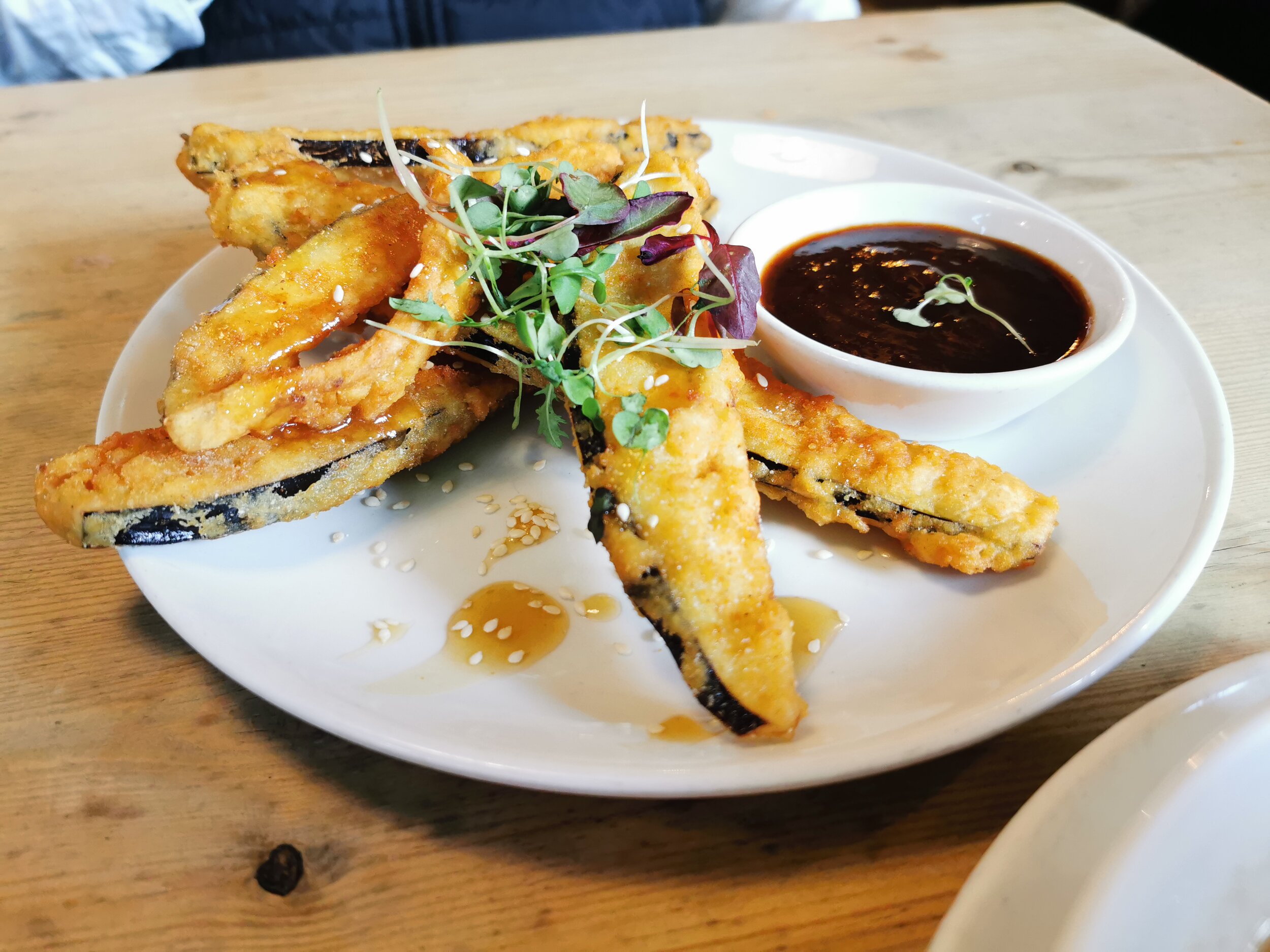 Miso Aubergine Fritters served with a smoked chilli &amp; soy dip &amp; topped with mixed seeds