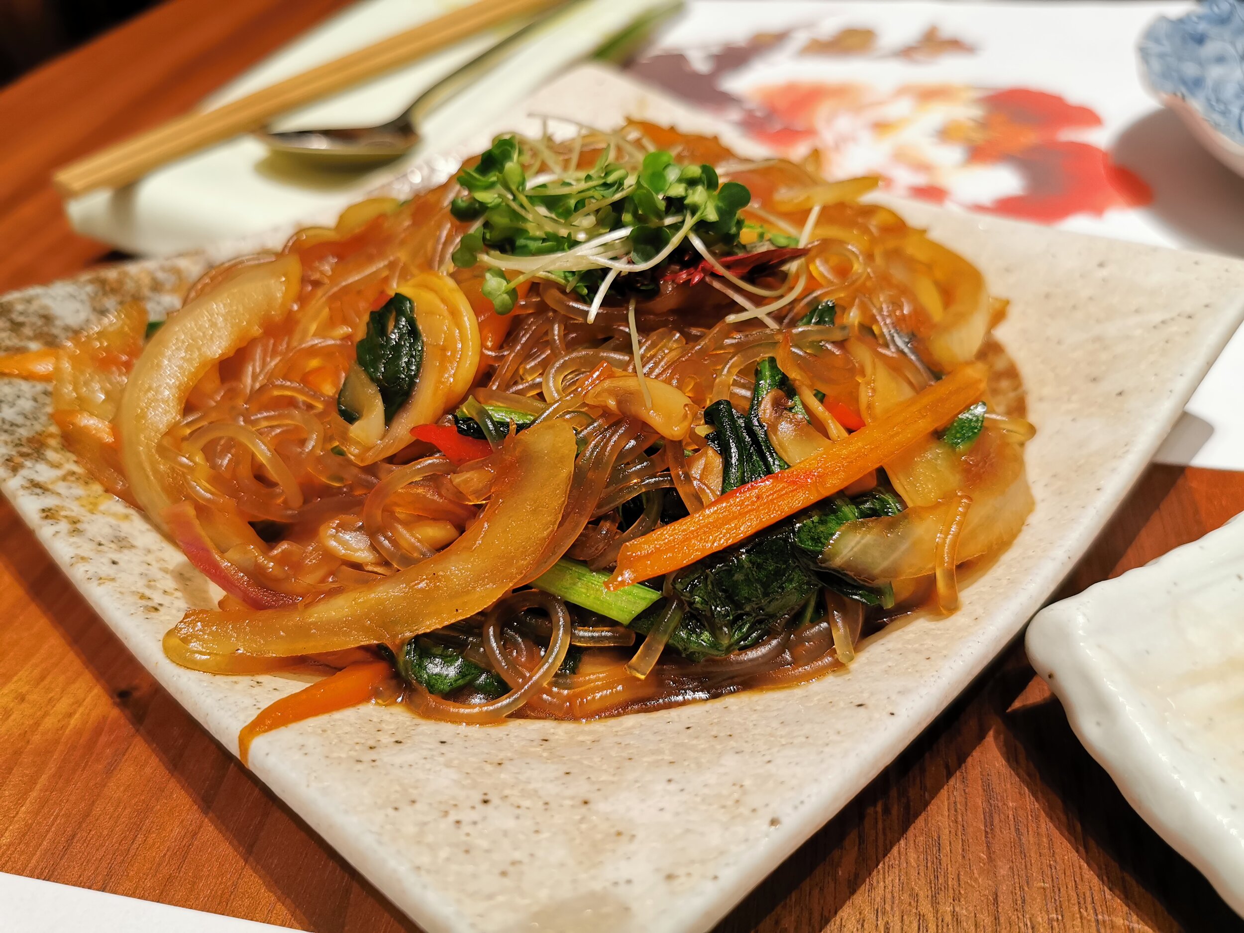 Vegan Korean glass noodles served with mixed vegetables in sesame oil