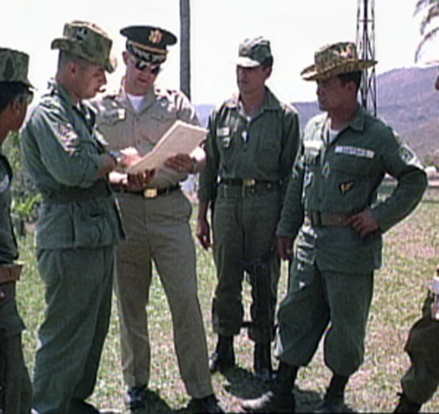 Coronel Carlos Arana Osorio y su ayudante se reunen con asesores del ejérito Estadounidense (1965) U.S. military advisers confer as Col. Carlos Arana Osorio (on the right) and an aide look on (U.S. Army, 1965)