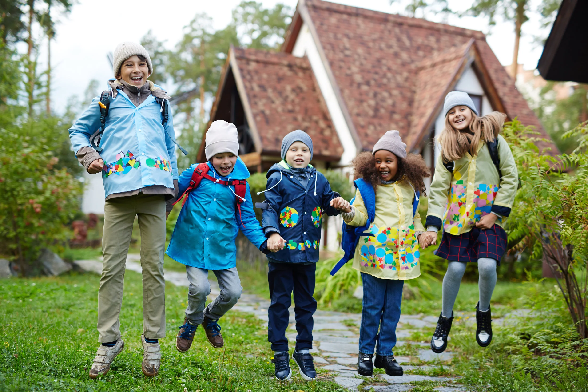 storyblocks-ecstatic-schoolkids-jumping-on-background-of-their-school_HaxyHNTXZz.jpg