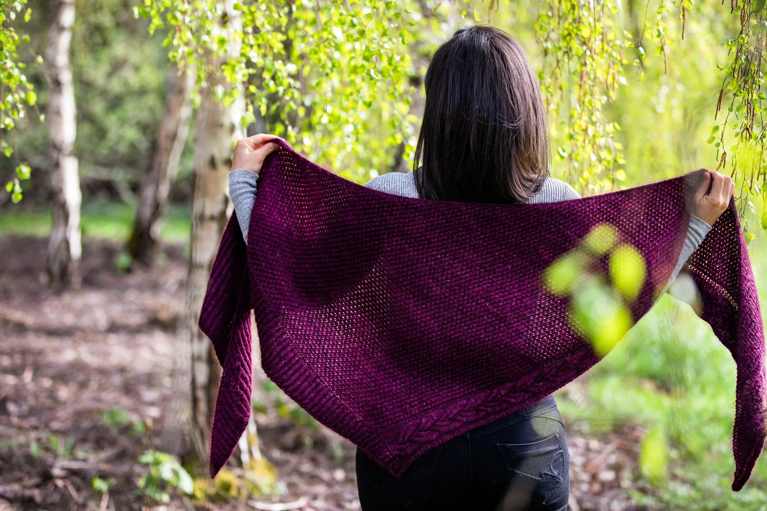 An alternative angle showing the rich texture and detail of the triangular Indira Shawl, featuring cables, lace, and fisherman's ribbing. Download the PDF knitting pattern from Vanessa Smith Designs.