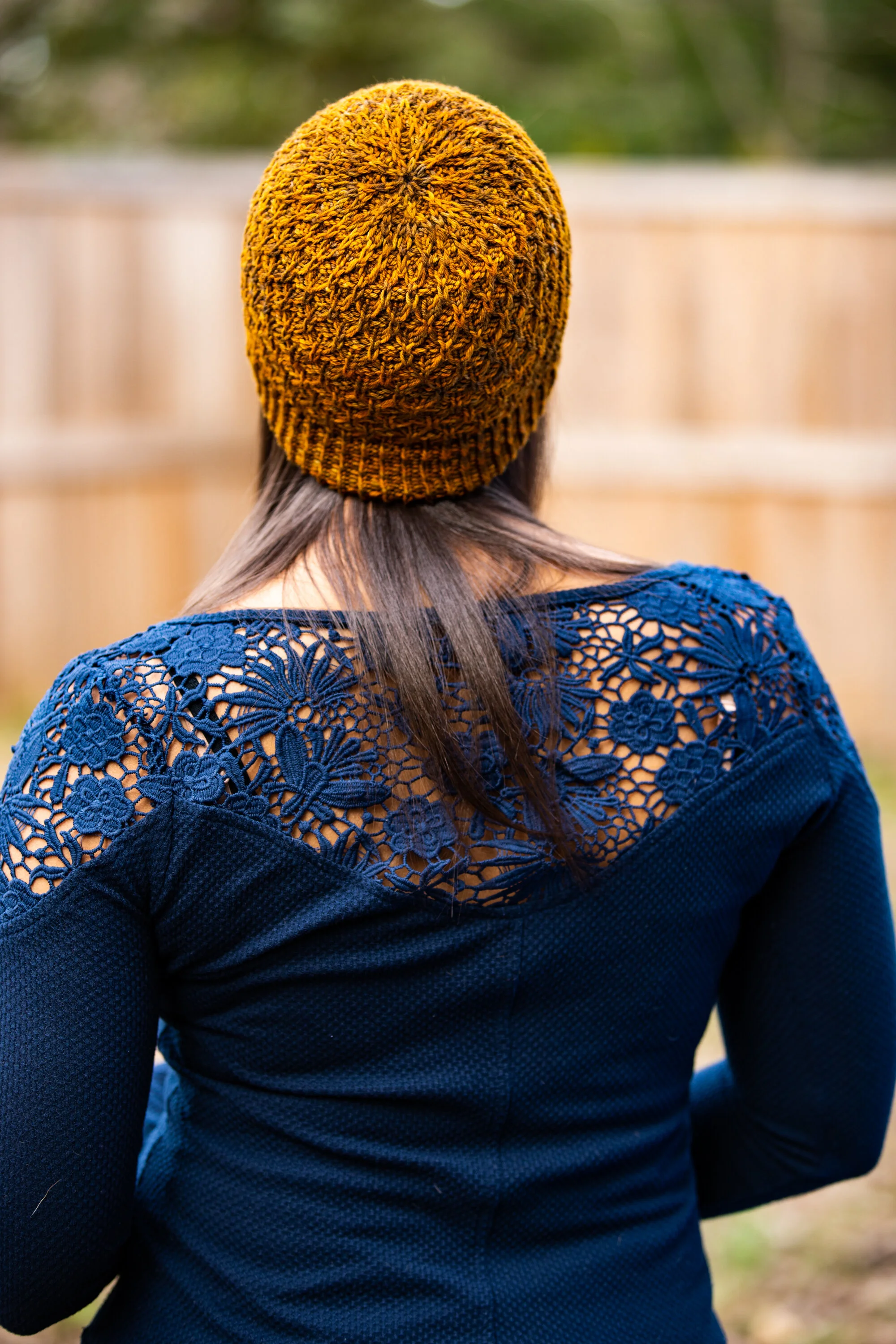 A top-down view of the Aslyn hat pattern, showing the beautiful crown details and all-over texture. Made with Malabrigo Arroyo in the colorway Glitter. PDF knitting pattern by Vanessa Smith Designs.