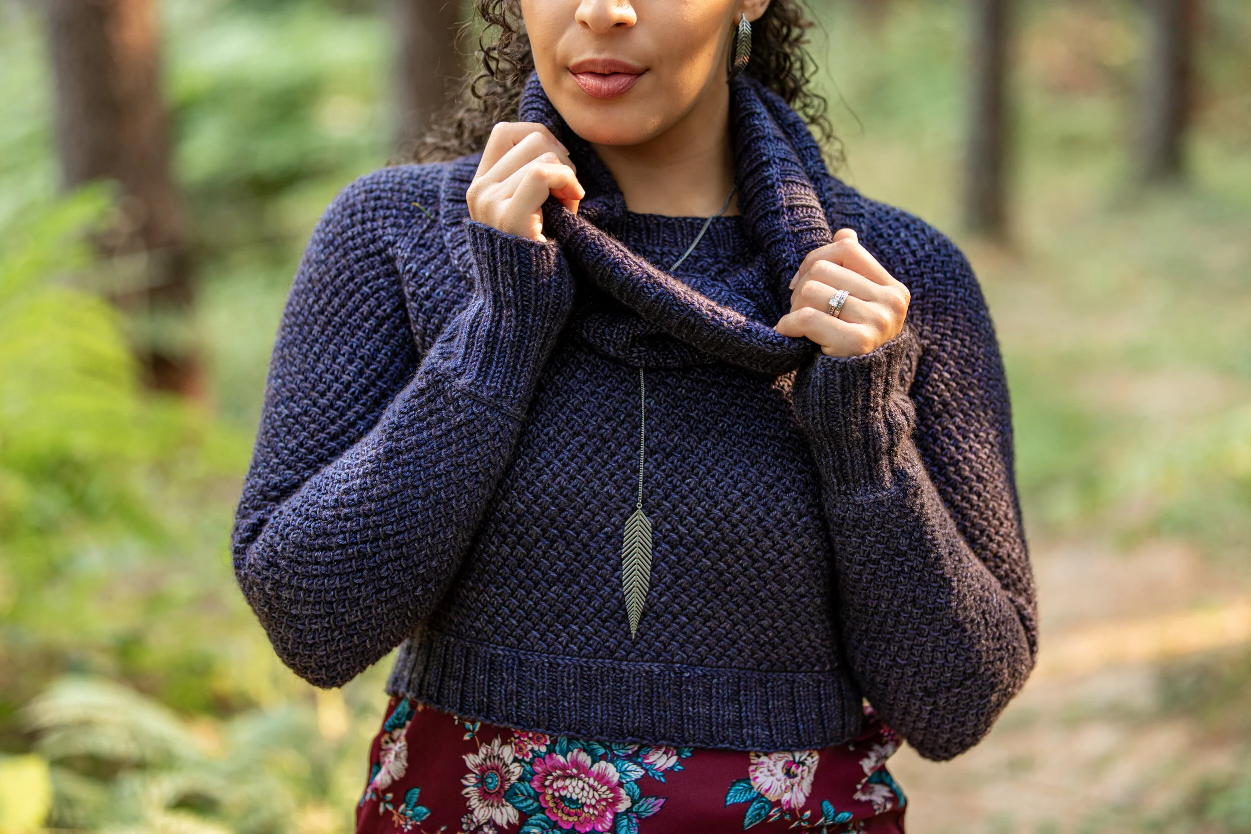 Styled view of Nydia, a fun-to-knit pullover worked seamlessly from the neck down in a simple lace stitch pattern. Instant PDF download by Vanessa Smith offers customization, including optional cowl.