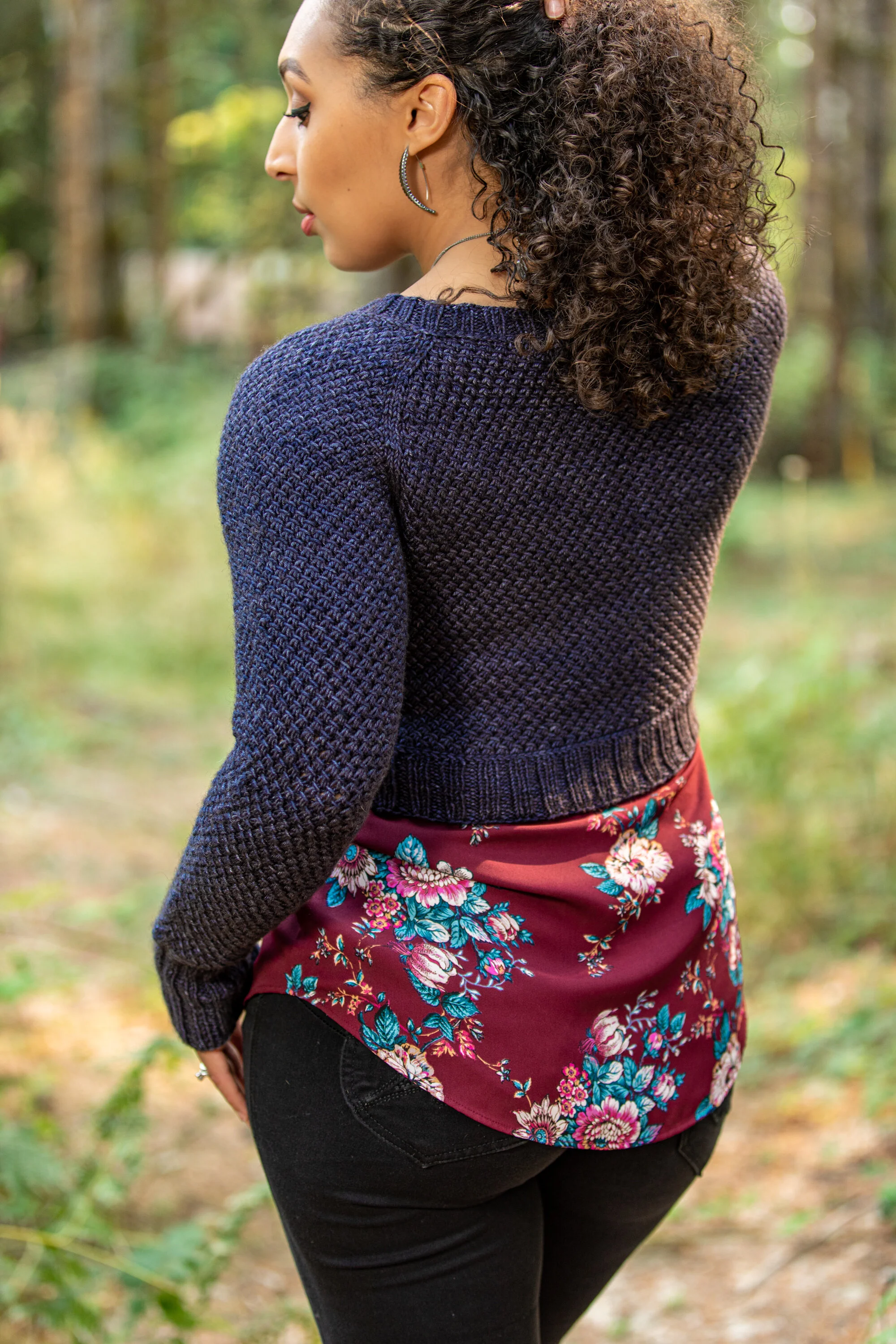 An alternate back view of Pacific Northwest knitting pattern designer Vanessa Smith's Nydia sweater, showing its tailored fit. Designed for women in petite to plus sizes with lots of fit customization