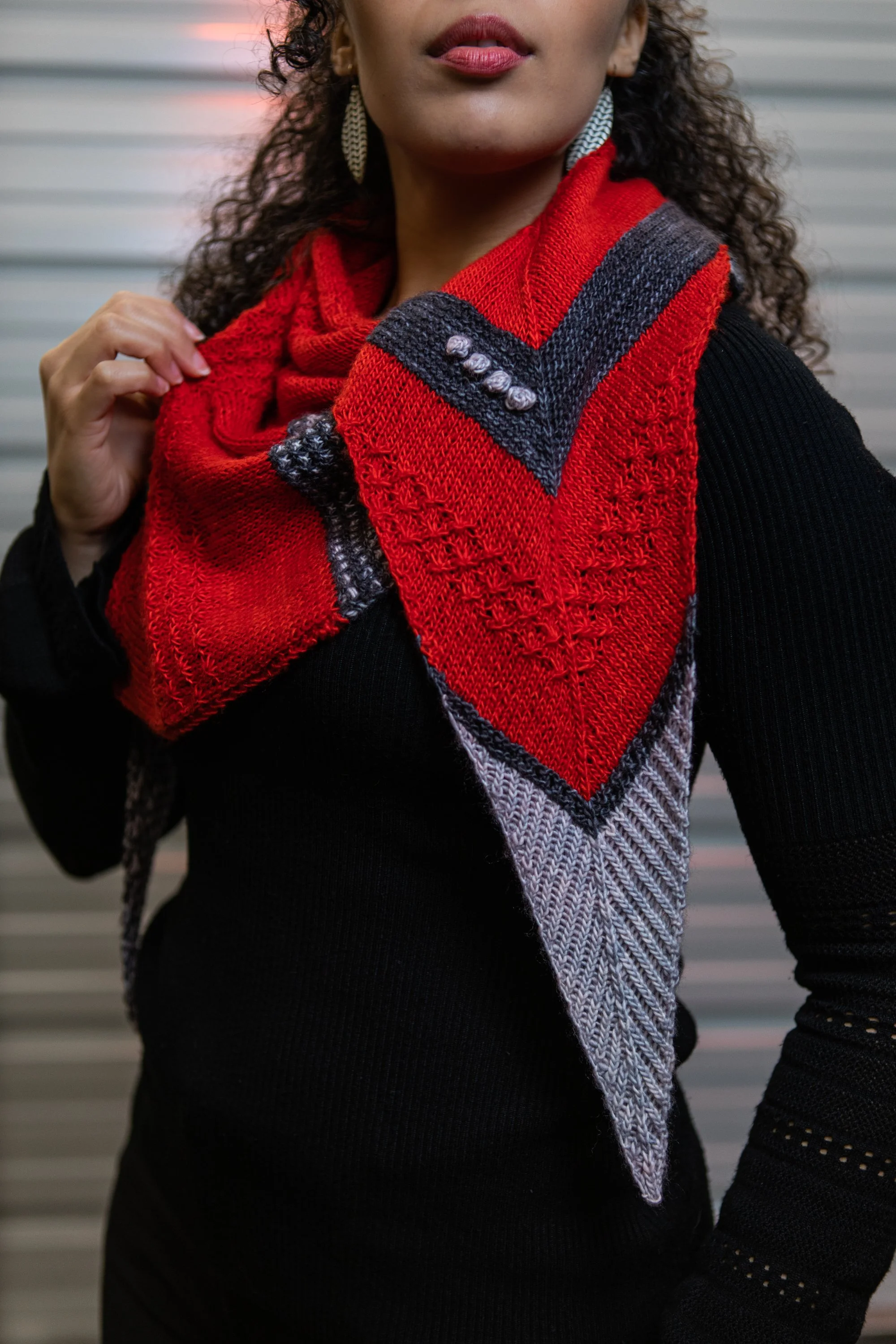 Twisted ribbing, texture, bobbles, and an interplay of color come together in Farpoint, a fun, intermediate shawl knitting pattern by Vanessa Smith. Inspired by Star Trek: TNG with a modern flair.